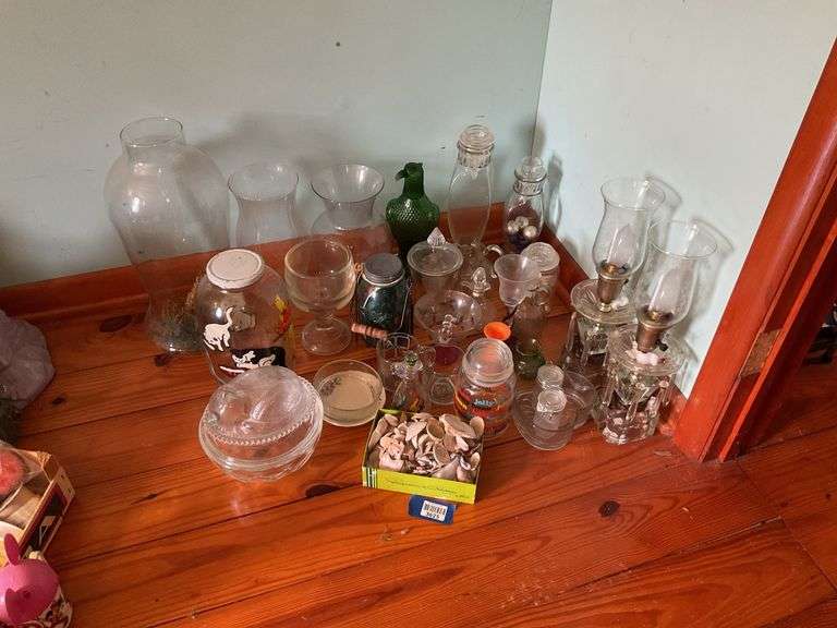 Corner lot: glass buffet lamps, green eagle decanter, kitten covered dish, vases, misc glass