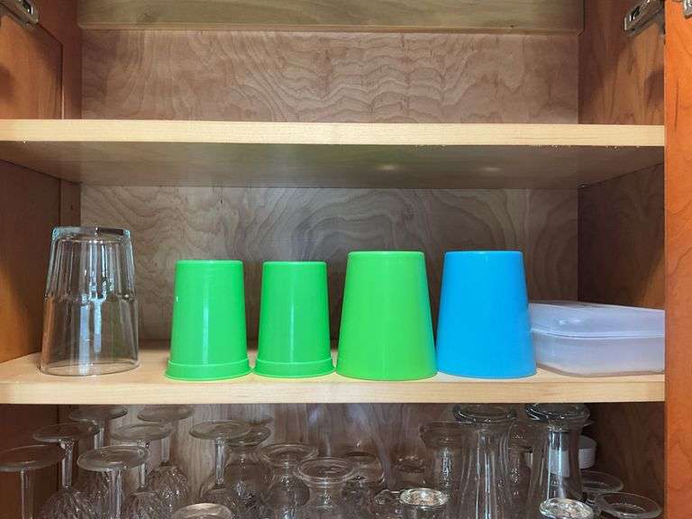 Contents of two cupboards: mugs, glasses, stemware, Halloween bowls, misc