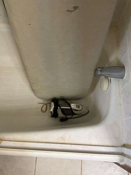 Contents of bathroom: iron, ironing board, rolling stand, waste basket, craft supplies, lightbubls