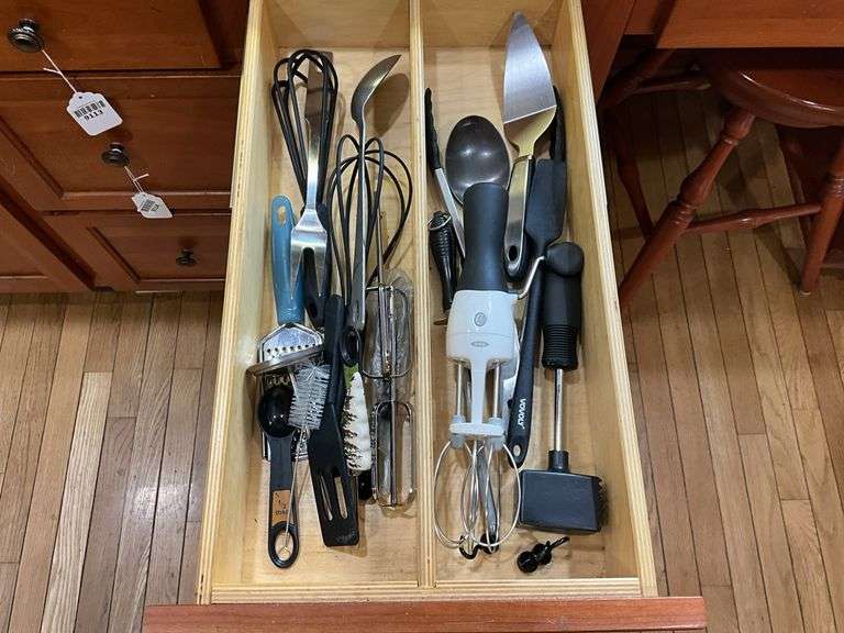 Contents of two drawers: utensils, measuring cups