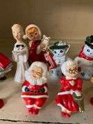 Contents of shelf: vintage china Santa and other Christmas figurines