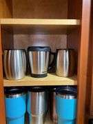 Contents of cupboard: travel mugs/tumblers