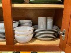 Contents of cupboard: Dansk stoneware dinnerware, green glazed pinecone motif dinnerware