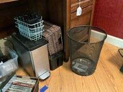 Contents of desk top and underneath: metal lamp, cable modem, twin, puzzles, office supplies, tape, waste cans, CDs, misc