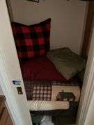Contents of closet: drapery panels, hangers, throw pillows, comforters