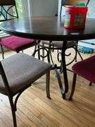 Wrought metal base table w/ round wooden top and set of four matching chairs w/ padded seats 44x44x30