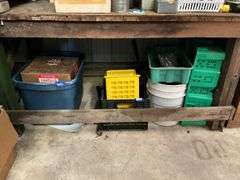 Items under workbench: plastic containers, mop wringer, grout and sand