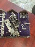 Antique sewing machine attachments in hinged box