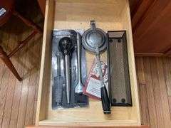 Contents of four drawers: gadgets, household items, measuring cups, power strip, misc
