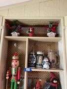 Contents of cupboard: nutcracker, Christmas figurines and decor, beer steins