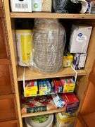 Contents of pantry cupboard: trash bags, paper goods, kitchen wrap, cookbook, misc