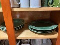 Contents of cupboard: Dansk stoneware dinnerware, green glazed pinecone motif dinnerware