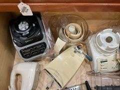 Contents of drawer: blenders, electric knife, hand mixer, grater