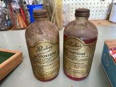 Four Peerless Motortone bottles w/ paper labels