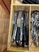 Contents of drawer: flatware, utensils