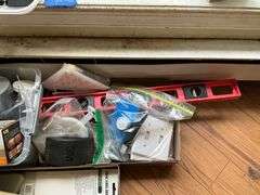 Floor lot and contents of windowsill: level, hand tools, painting supplies, laser level, misc
