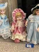 Four porcelain collector dolls