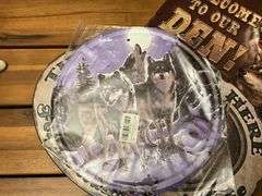 Three metal wolf plaques