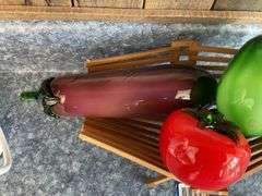 Blown art glass vegetables on wooden basket