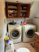 Contents of bath/laundry room: Bath stool, towels, heath & body products, walker, under sink contents, wall plaque, misc. Washer and Dryer NOT FOR SALE.