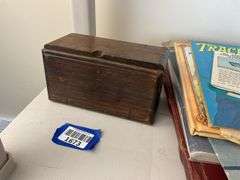 Antique sewing machine attachments in hinged box