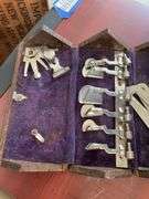 Antique sewing machine attachments in hinged box