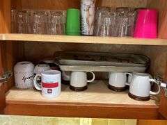 Contents of two cupboards: mugs, glasses, stemware, Halloween bowls, misc