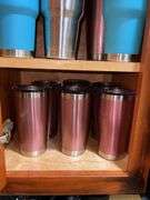 Contents of cupboard: travel mugs/tumblers