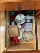 Contents of four drawers: gadgets, household items, measuring cups, power strip, misc