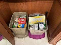Contents of bathroom: iron, ironing board, rolling stand, waste basket, craft supplies, lightbubls