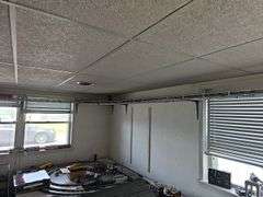 Wire shelving and train track near ceiling level, bring tools for ...