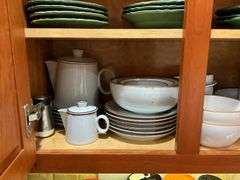 Contents of cupboard: Dansk stoneware dinnerware, green glazed pinecone motif dinnerware