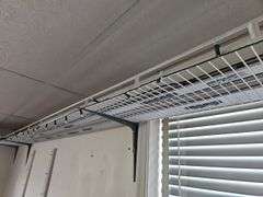 Wire shelving and train track near ceiling level, bring tools for ...