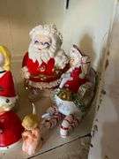 Contents of shelf: vintage china Santa and other Christmas figurines