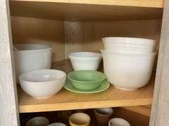 Contents of cupboard: vintage coffee mugs, jadeite glass, milk glass mixer bowls, 2-handle ribbed glass bowl