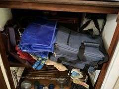 Contents of closet: hand weights, wire shelving, luggage, bags, misc