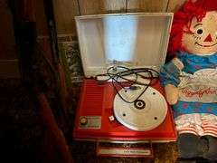 Vintage riding horse and contents of closet: baby scale, toy rifles, child's turntable, Raggedy Ann & Andy dolls, toy cars, misc toys