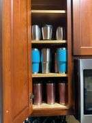Contents of cupboard: travel mugs/tumblers