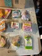 Large lot of vintage Happy Meal toys in packages including: Power Rangers, Flintstones, Barbie, Nintendo