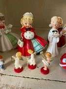 Contents of shelf: vintage china Santa and other Christmas figurines