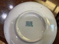 Contents of cupboard: Dansk stoneware dinnerware, green glazed pinecone motif dinnerware