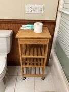 Contents of bathroom: iron, ironing board, rolling stand, waste basket, craft supplies, lightbubls
