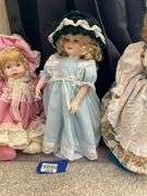 Four porcelain collector dolls