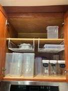 Contents of two shelves: plastic storage containers