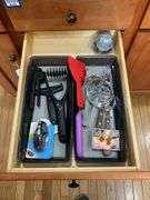 Contents of four drawers and one cupboard: coasters, baking pans, gadgets, hot pads, rolling pin, misc