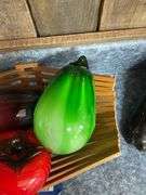 Blown art glass vegetables on wooden basket