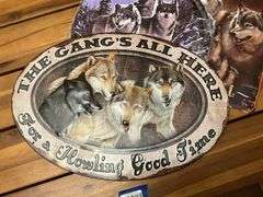 Three metal wolf plaques