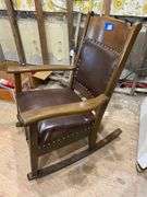 Turn-of-the-century oak rocking chair w/ upholstered seat and back panel