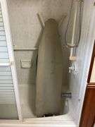 Contents of bathroom: iron, ironing board, rolling stand, waste basket, craft supplies, lightbubls