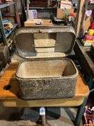 Contents of shelf: vintage cosmetic case, movie reels, metal toolbox, roll of plastic